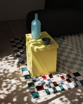 a colorful checkerboard rug with different scales
