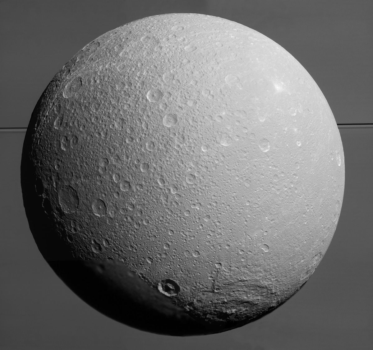 Dione with Saturn and its rings.
