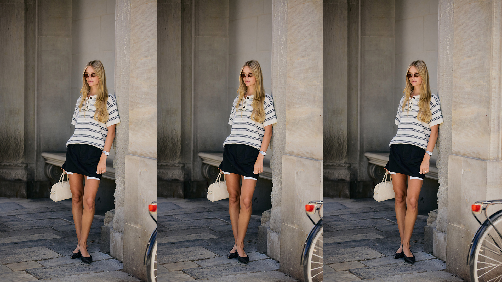 Woman wears striped polo top with black miniskirt and white handbag. 