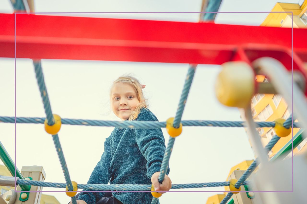 Girl on playground looking at camera