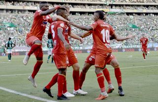 America de Cali players celebrate a goal against Deportivo Cali in March 2019.