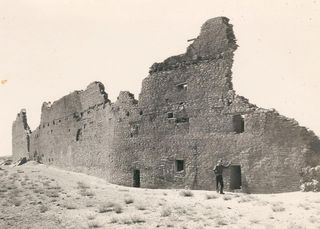 Shown here, the back, curved wall (north) of Pueblo Bonito, taken northwest of the site of Chaco Canyon.