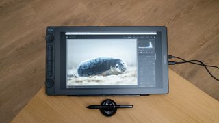 Huion Kamvas 16 (Gen 3) drawing tablet on a wooden desk