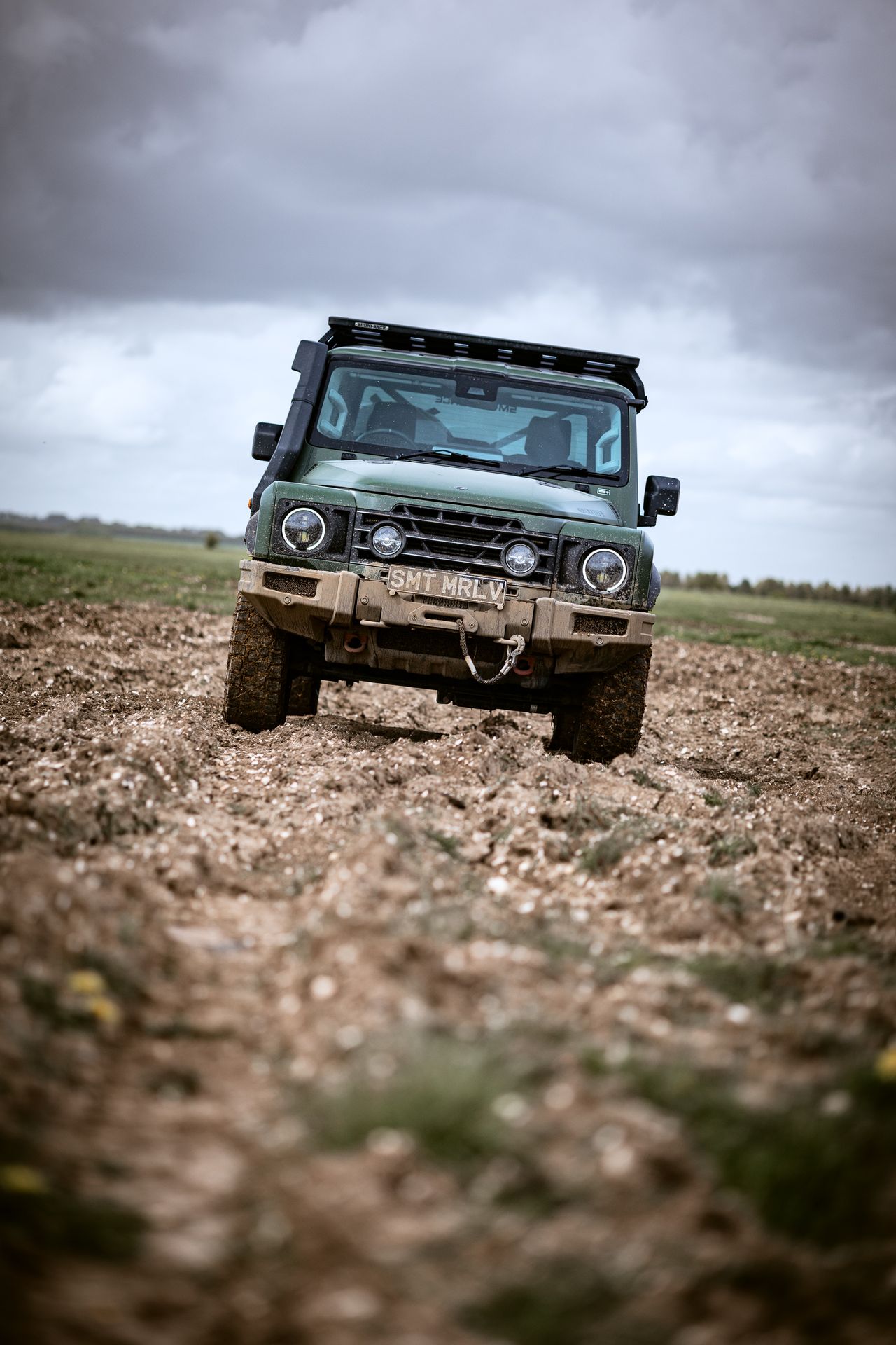 Image of the Ineos Grenadier looking exceptionally muddy. It's a flat-bed style pickup