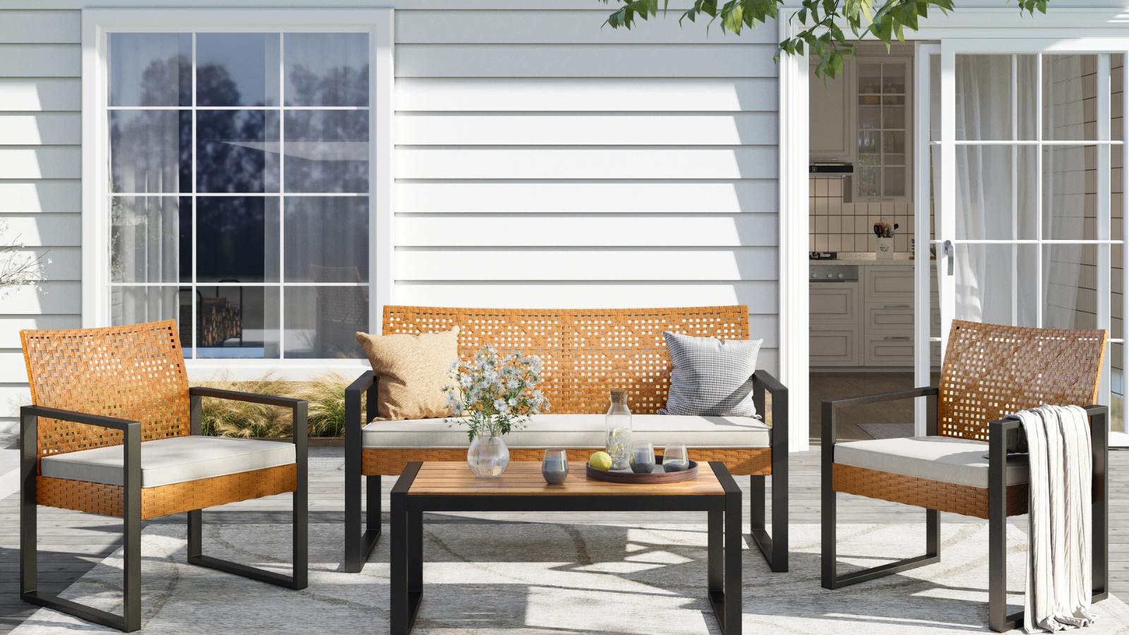 an outdoor seating area with two chairs, a loveseat, and a coffee table