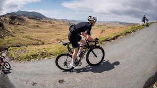 Tom Wieckowski climbs one of the many hills at the Fred Whitton 2022