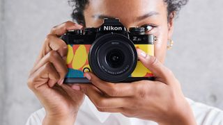 Woman shooting with Nikon Zfc camera with Heralbony graphics