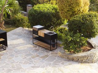 outdoor kitchen idea with integrated sink on a large paved terrace space