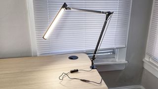 Uplift E7 Desk Lamp clamped to a standing desk