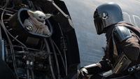 an armored warrior and a baby green alien