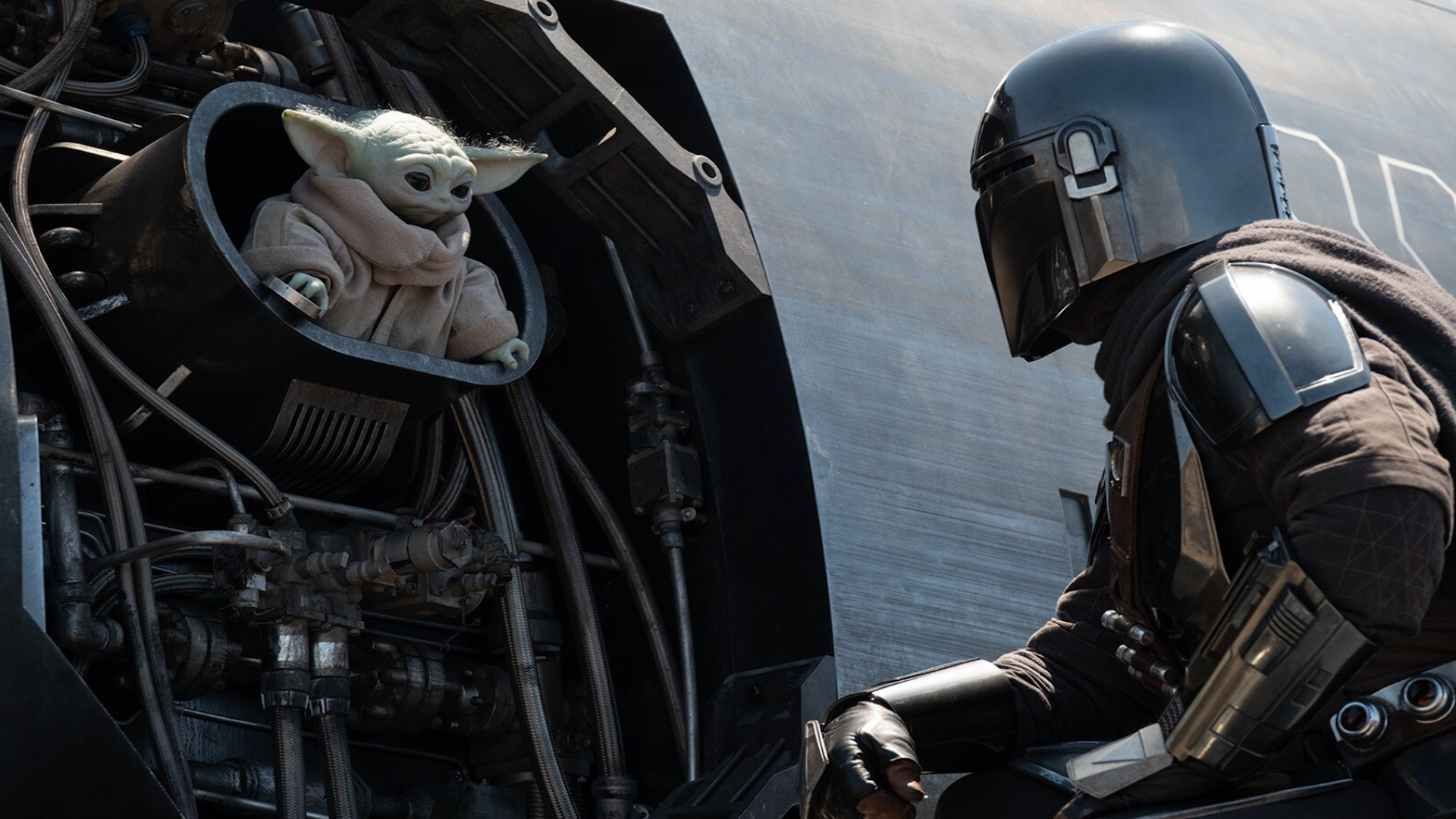 an armored warrior and a baby green alien