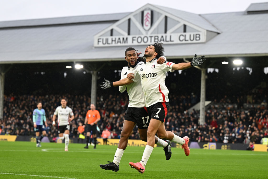 Fulham's Mexican striker #07 Raul Jimenez (R) celebrates with Fulham's Nigerian midfielder #17 Alex Iwobi (C) after scoring the opening goal during the English Premier League football match between Fulham and Arsenal at Craven Cottage in London on December 8, 2024.