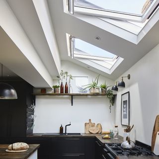 kitchen with roof windows black cabinets and wooden shelf