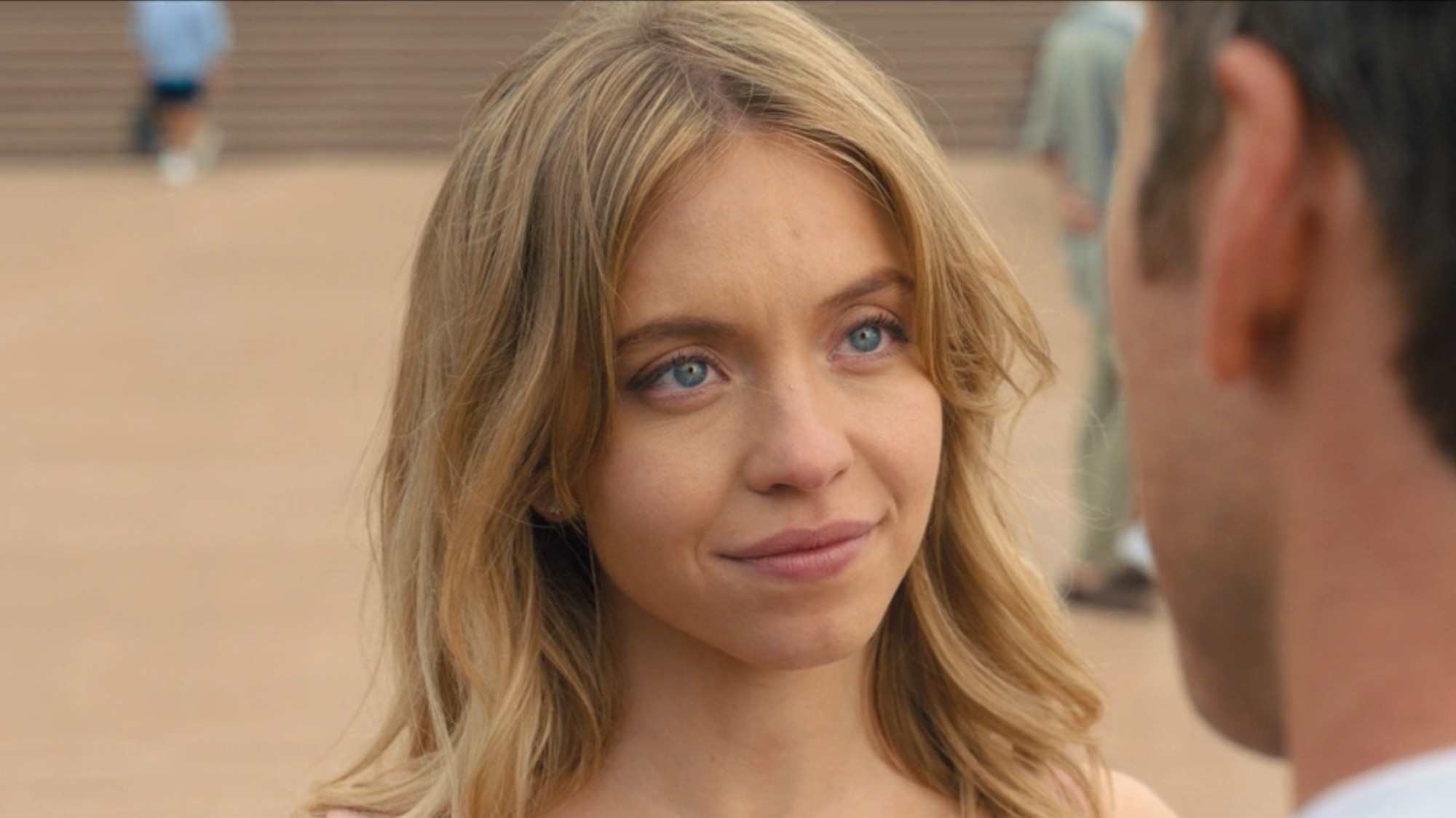 A close up of Sydney Sweeney looking happy in Anyone But You. 