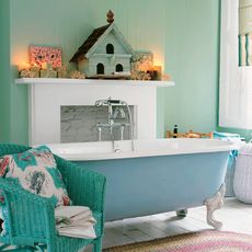 green and blue bathroom with wooden house and white fireplace