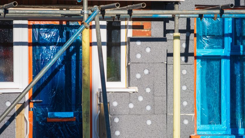 home with scaffolding while external wall insulation is being added