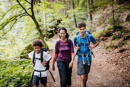 day hike essentials: family going on a day hike in the forest