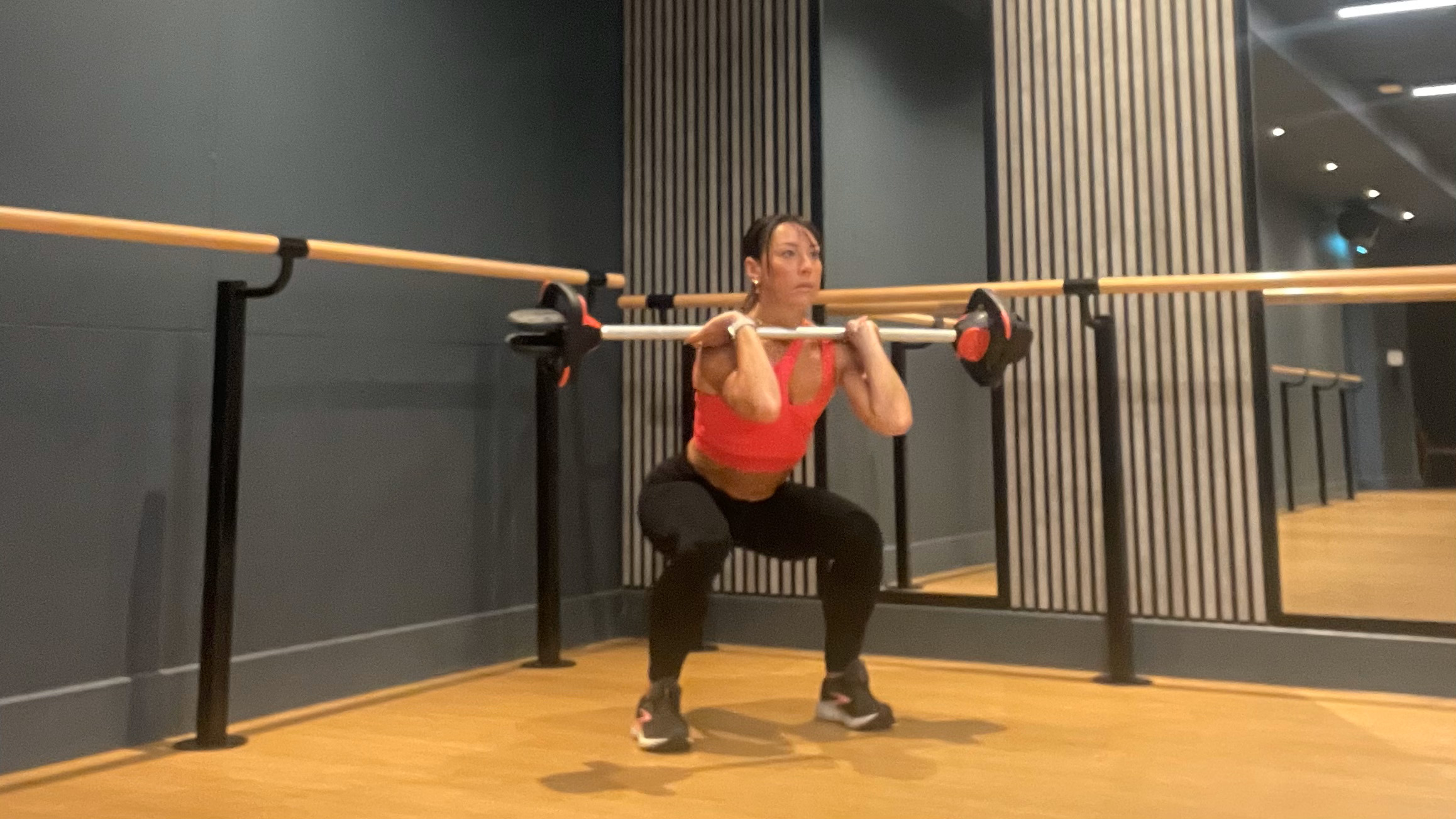 Lucy performing barbell front squat