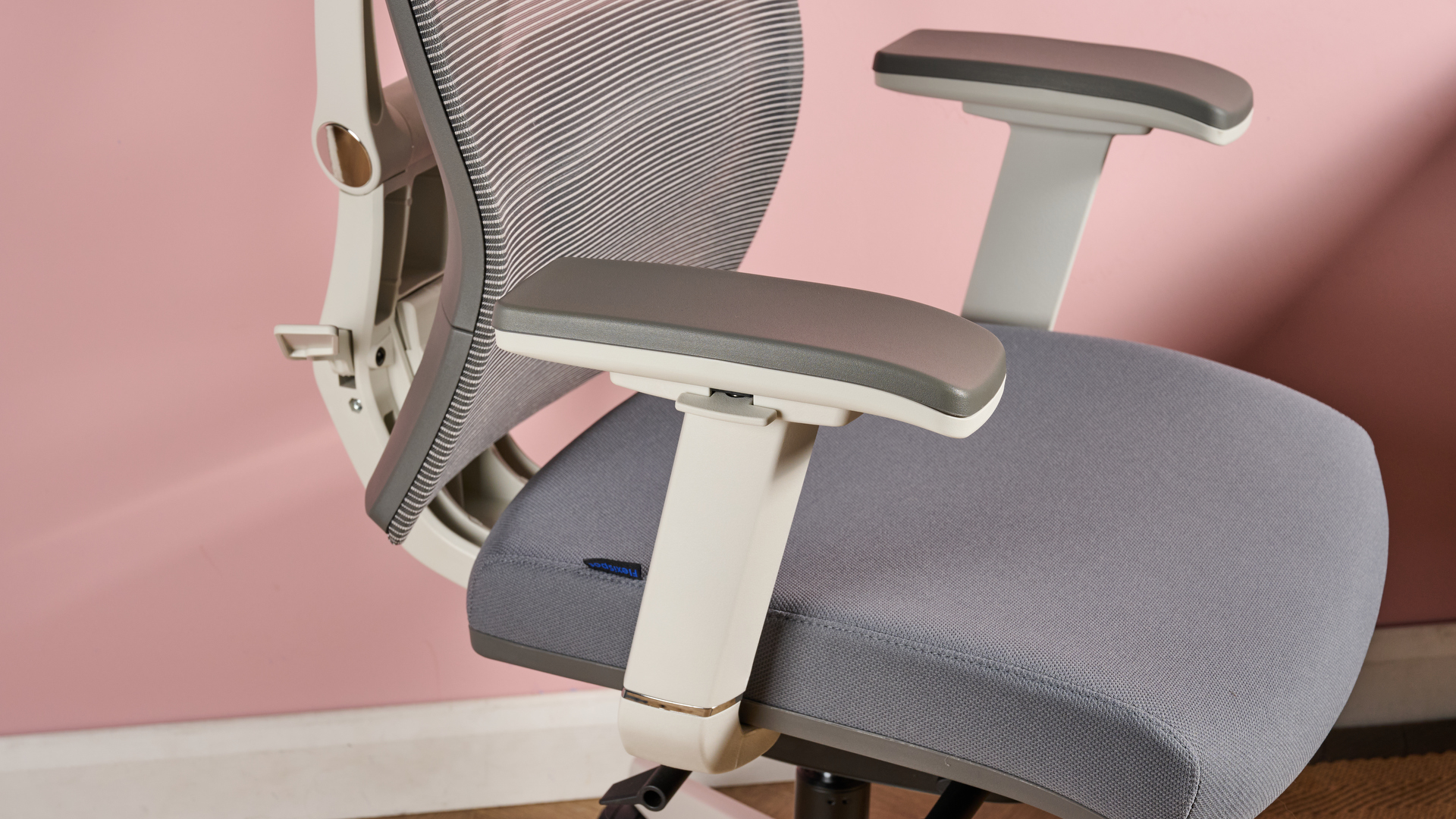 A close-up of the left armrest and adjustment lever.