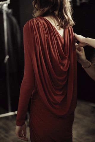 Woman in a red dress from H&M Studio Holiday Capsule