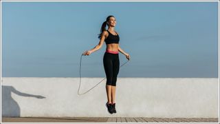 Young woman training with a jumping rope