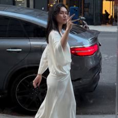 @mimixn wearing a flowy Easton Marley heatwave-proof dress in New York City.