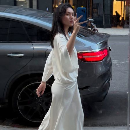 @mimixn wearing a flowy Easton Marley heatwave-proof dress in New York City.