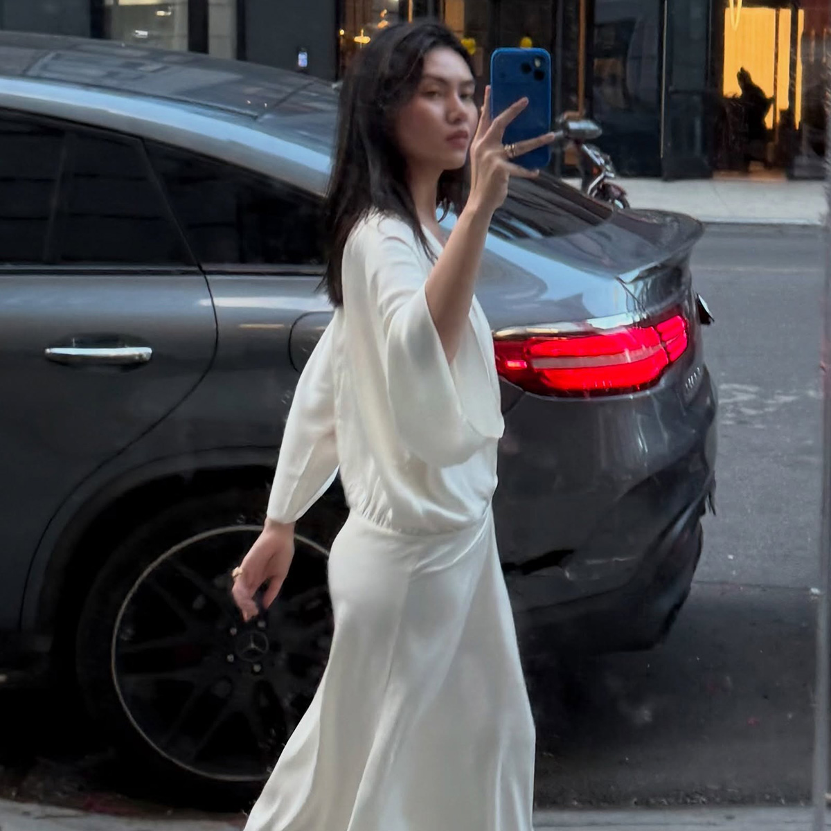 @mimixn wearing a flowy Easton Marley heatwave-proof dress in New York City.