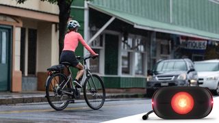 A woman riding an e-bike down a street