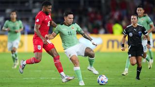 Carmelo Algarañaz of Bolivia shields the ball from Carlos Harvey of Panama in a Copa America 2024 match