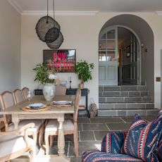 Dining area with wooden table and chairs on flagstone flooring