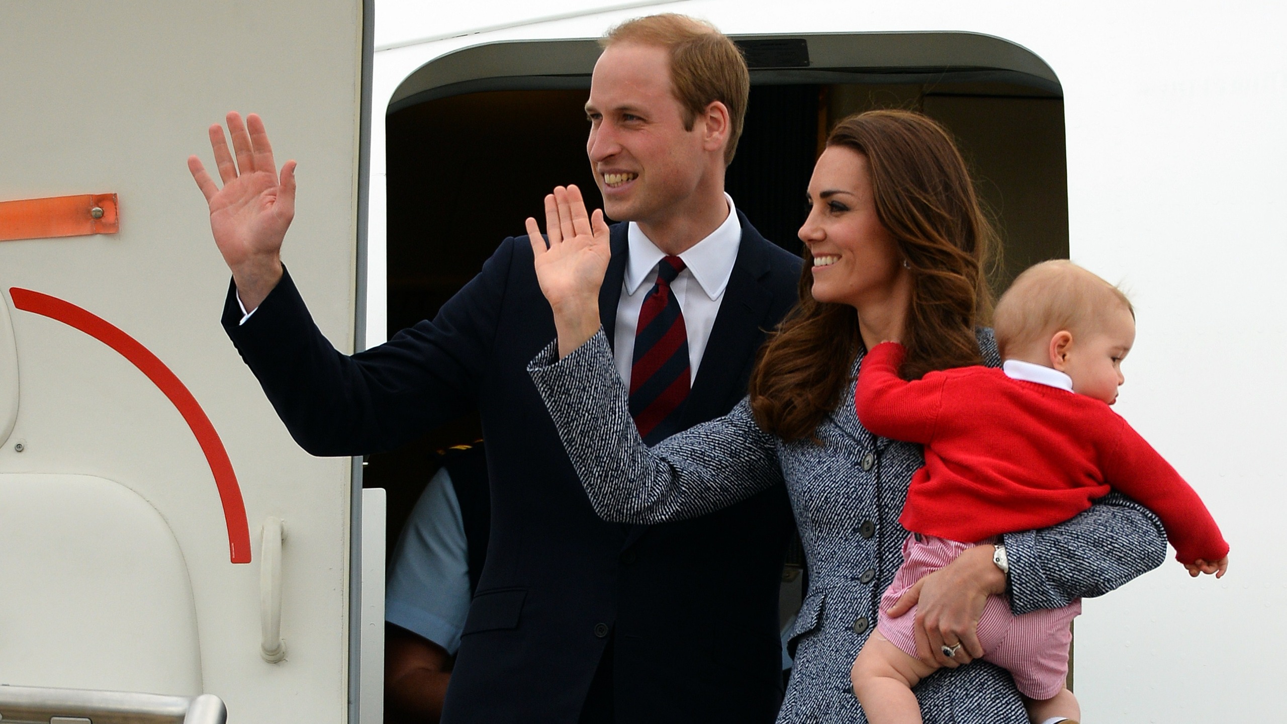 Prince William, Catherine and their baby son Prince George wave as they depart Australia from Defence Establishment Fairbairn in Canberra on April 25, 2014