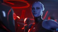 A blue-skinned woman with crest-like head tendrils and facial markings stands in a dimly lit, red-toned room wearing a dark, high-collared outfit.