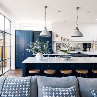 kitchen with white wall and navy blue cabinet with white countertop