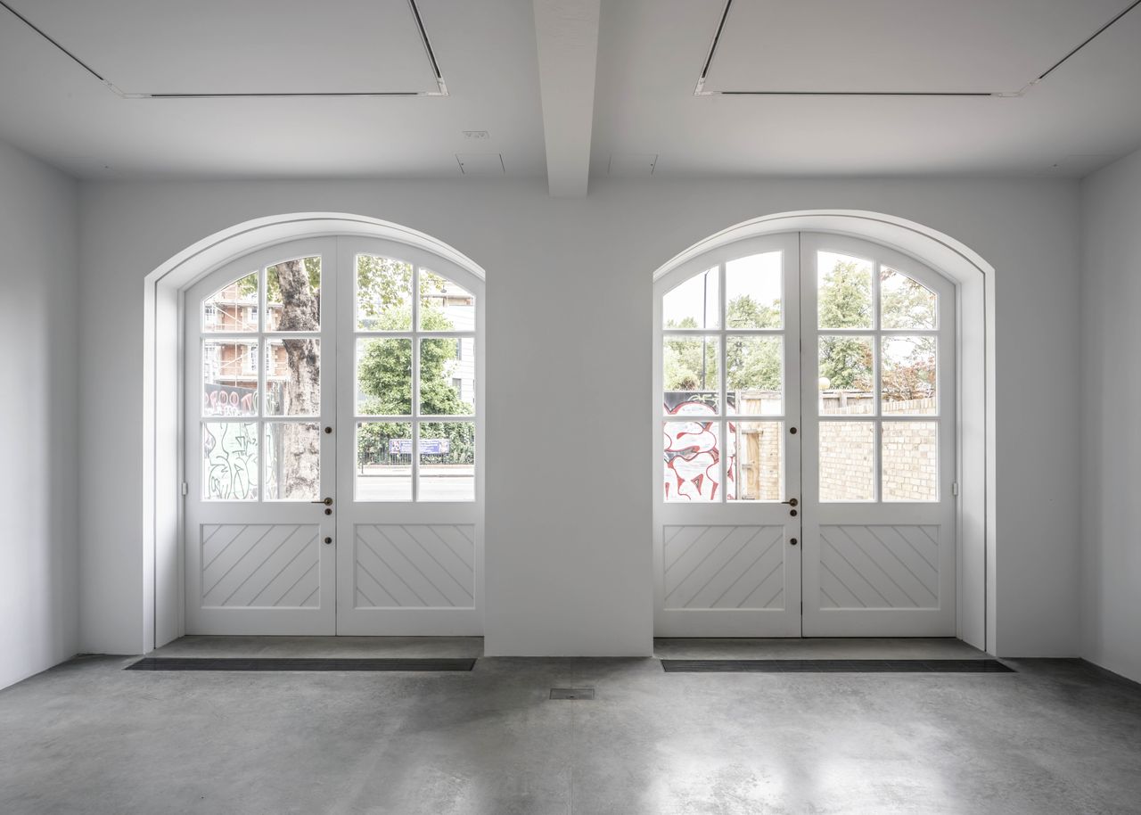 Renovated interior of fire station with large white painted doors