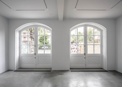 Renovated interior of fire station with large white painted doors