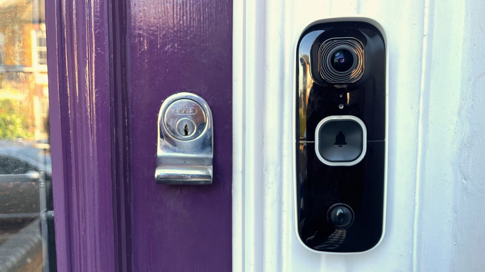 SwannBuddy4K Video Doorbell mounted beside purple door
