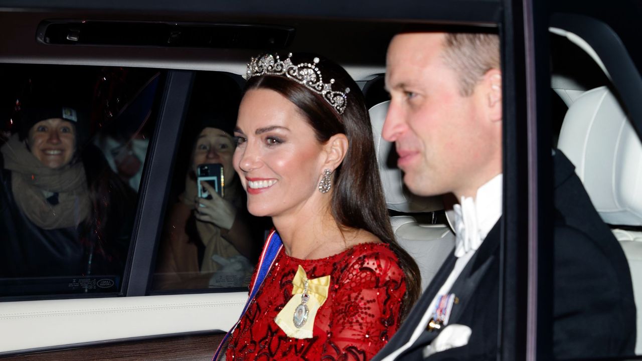 The Prince and Princess of Wales arrive in a car to attend a reception for members of the Diplomatic Corps