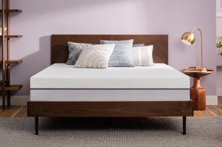 Emma vs Purple image shows the Purple Original mattress in a purple bedroom