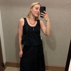 Woman wears black blouse and black skirt, both from Abercrombie & Fitch