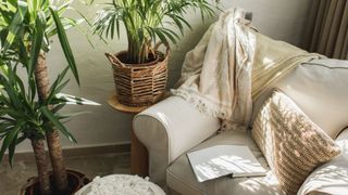 A cream sofa with cosy throws