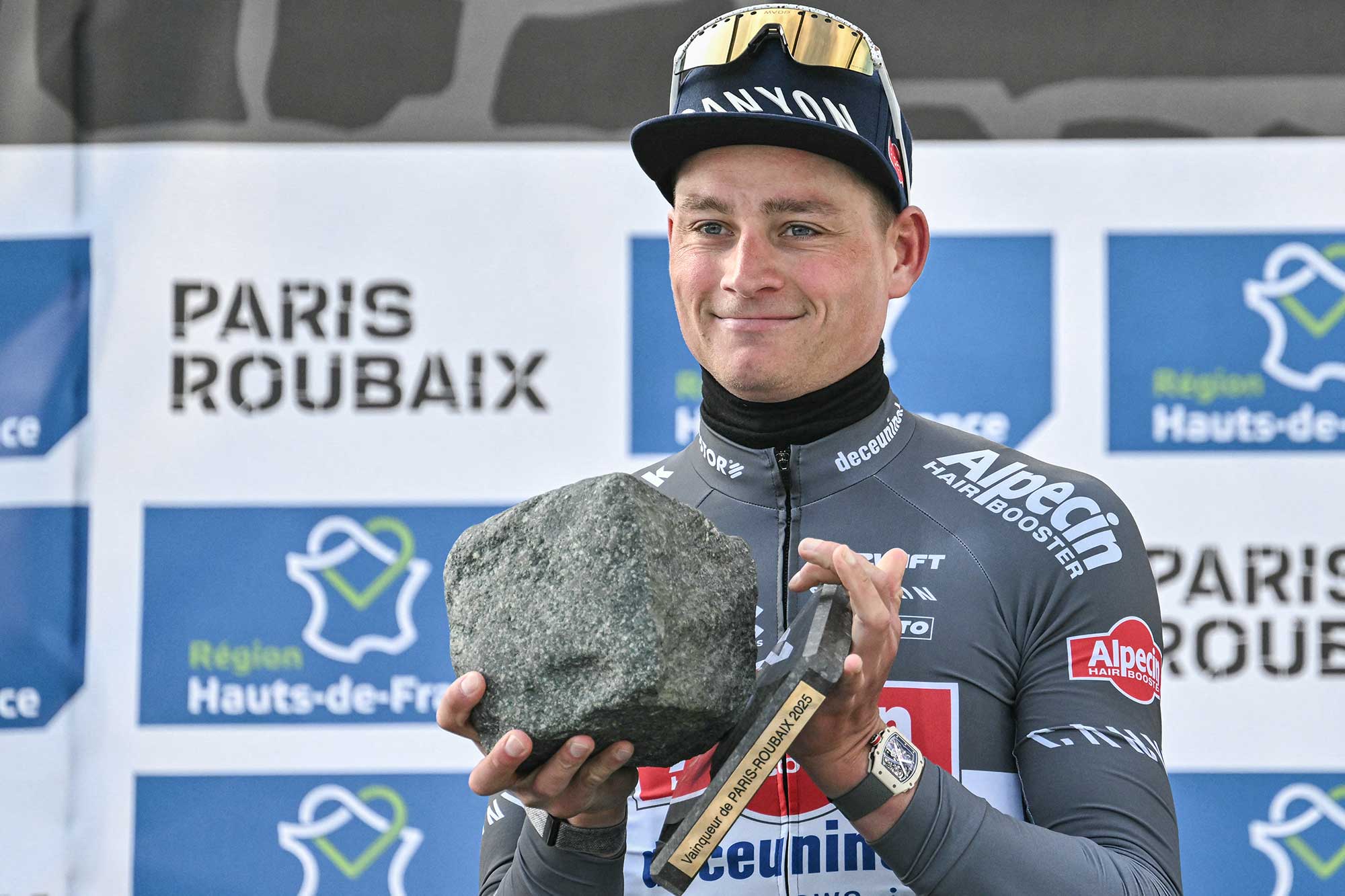 First placed Alpecin-Deceuninck&#039;s Dutch rider Mathieu van der Poel celebrates with his award on the podium of the 122nd edition of the Paris-Roubaix one-day classic cycling race, 259,2 km between Compiegne and Roubaix, northern France on April 13, 2025. (Photo by Jeff PACHOUD / AFP) (Photo by JEFF PACHOUD/AFP via Getty Images)
