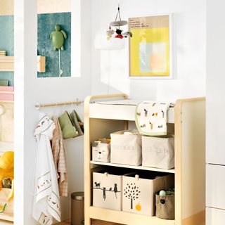 White bedroom with wooden changing table