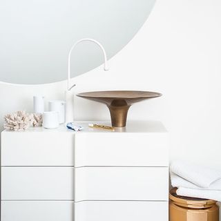 bathroom with bronze wash basin and white wall