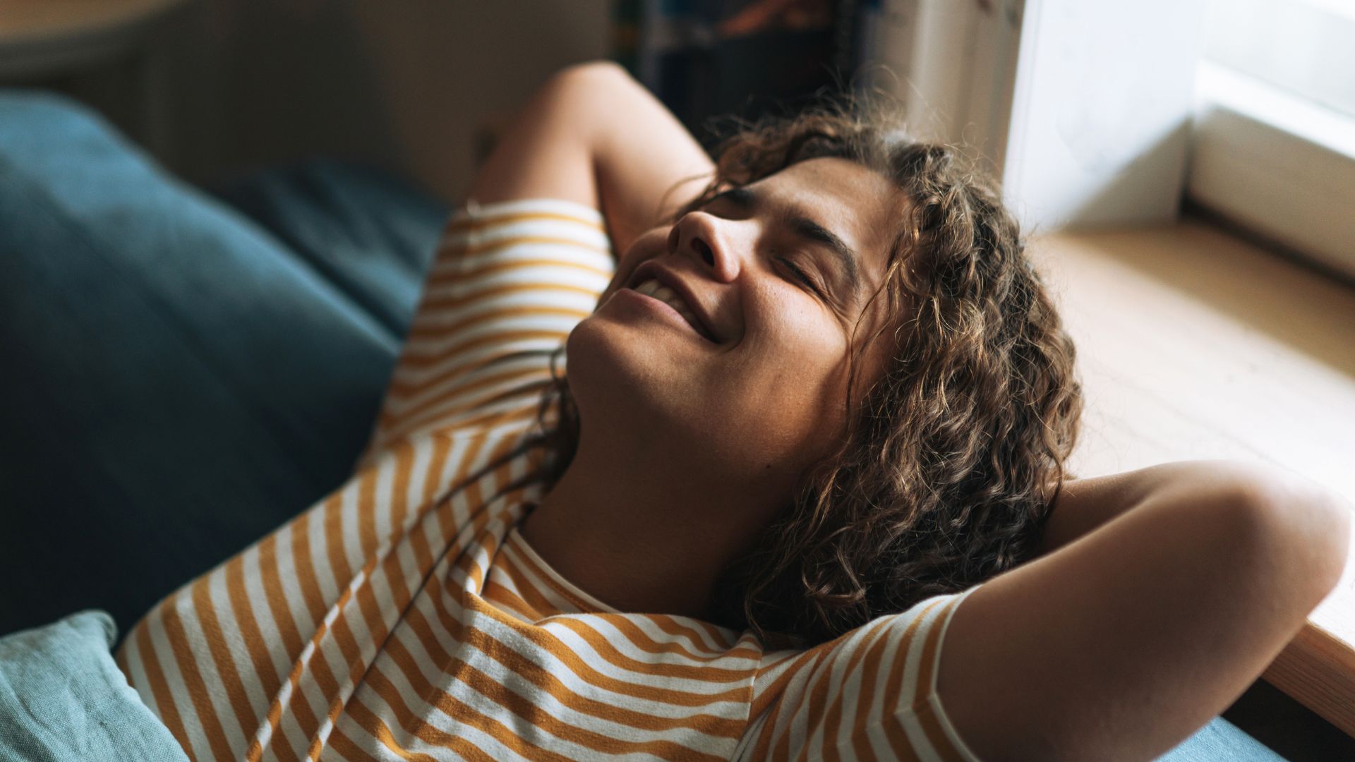 Woman lying down on sofa