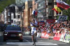 Tadej Pogacar points to the sky after victorious Leige-Bastogne-Liege after death of former teammate