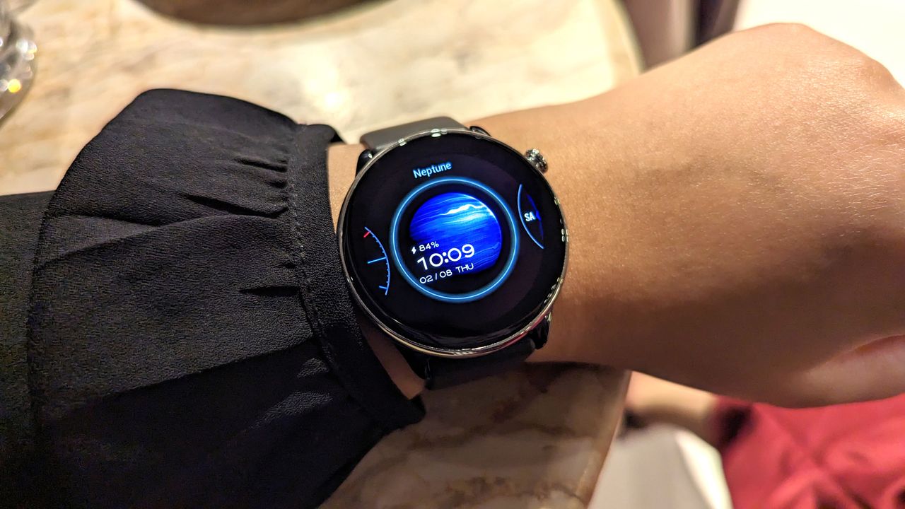 Amazfit GTR Mini smartwatch worn on a wrist, showcasing different watch face options.