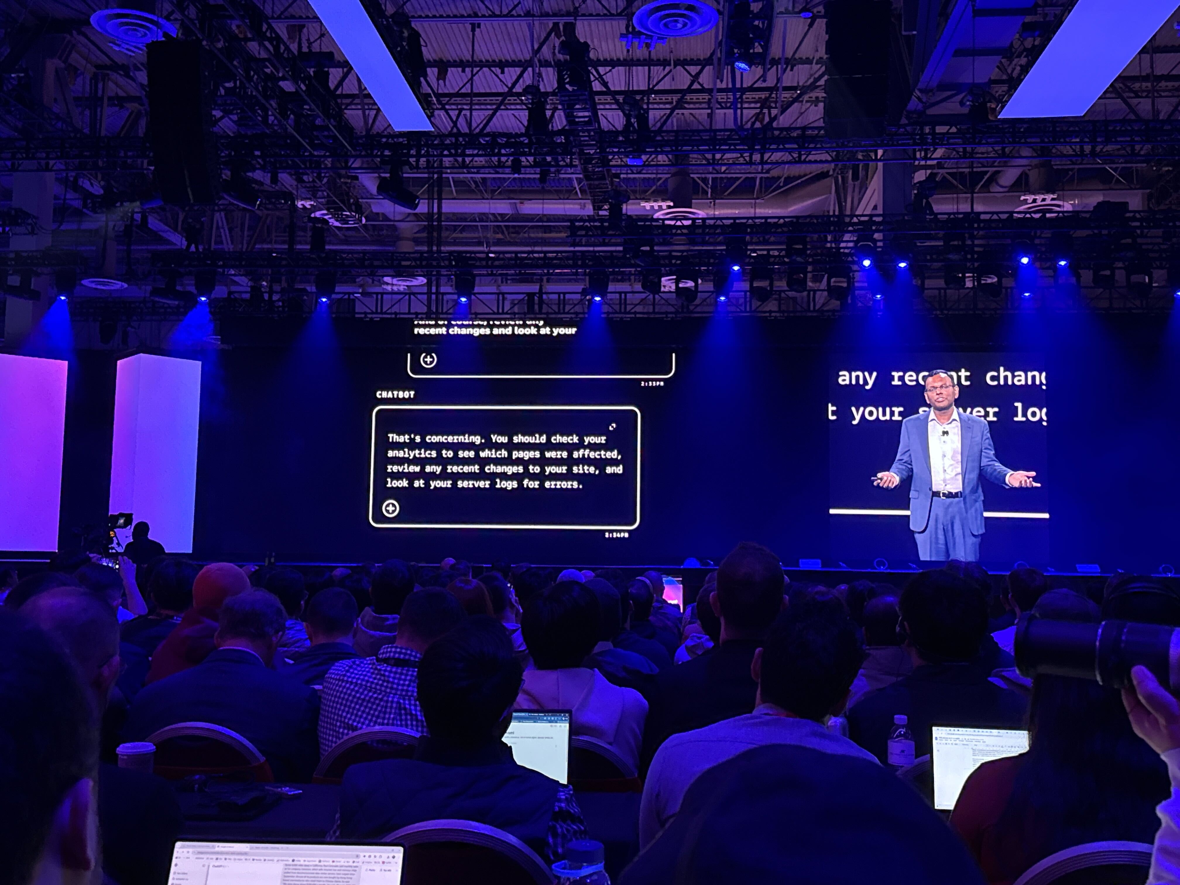 Swami Sivasubramanian pictured on stage at AWS re:Invent discussing the differences between AI chatbots and agentic AI.