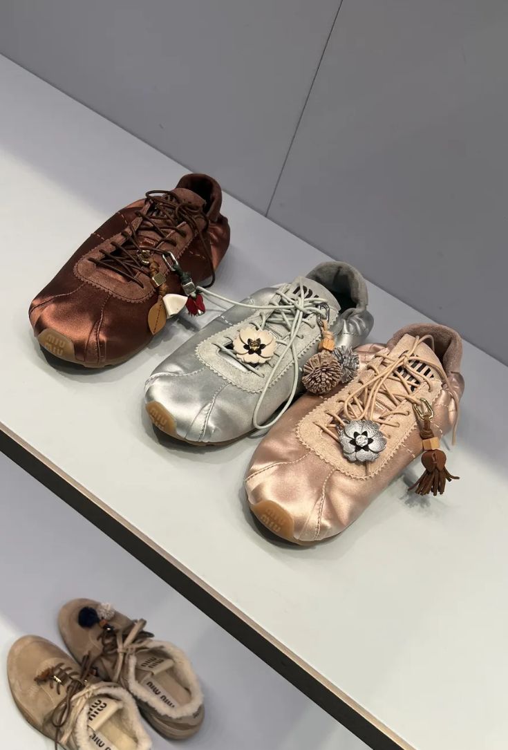 An image of @avahgilchrist wearing satin trainers.