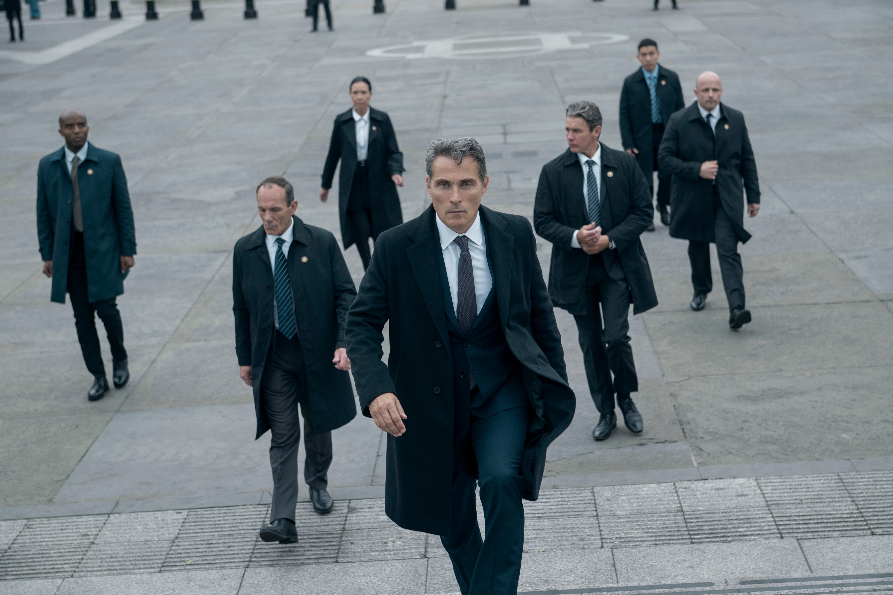 rufus sewell as hal leading a group of men in suits in the diplomat season 3